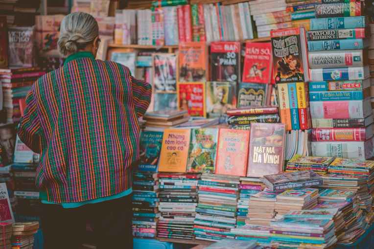woman standing beside book store